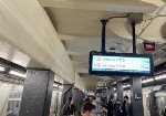 The regular F train on the left and the holiday train on the right, both at 2nd Ave Sta